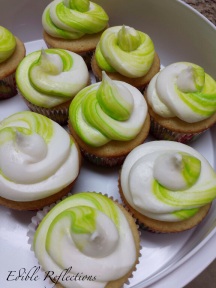 Vanilla cupcakes with a swirl of neon green food coloring in the buttercream